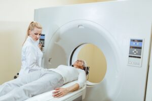 female-medical-technician-mature-patient-ct-scan-procedure-examination-room-hospital-min
